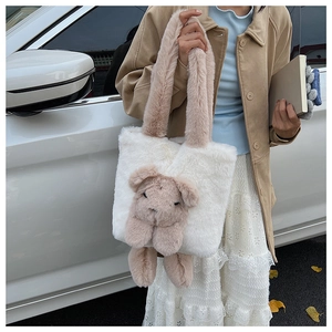 Detail of color-block plush tote bag featuring a cute 3D bear on soft faux fur