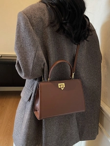 Vintage brown leather crossbody handbag with gold clasp for professional women