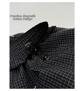 Detail shot of the secure silver magnetic buckle on a black and white plaid backpack