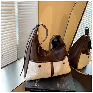 Detail view of vintage brown leather tote with white faux fur pockets and adjustable strap