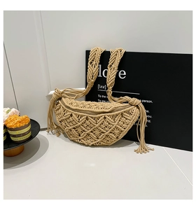 Detail view of beige hand-woven macrame chest bag with zipper and long tassels