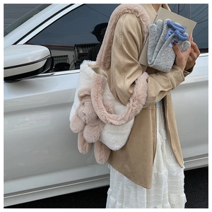 Detail of plush faux fur tote bag featuring cute 3D bunny accents and soft furry handle