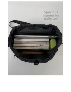 Interior view showing the large capacity of the plaid drawstring backpack with laptop and books