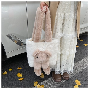 Detail of plush contrast teddy bear tote bag with soft faux fur texture and sturdy handle