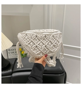 Detailed close-up of macramé woven texture and fringe on this bohemian white chest bag