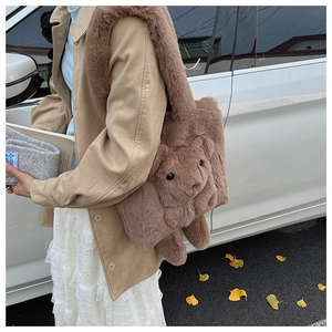 Detailed texture of brown plush tote bag featuring a cute 3D stuffed bear accessory