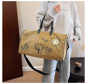 Close-up of graffiti canvas travel bag with leather handles and versatile shoulder strap