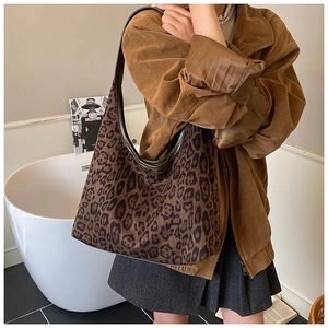 Detailed view of the large leopard print tote bag with dark green shoulder strap