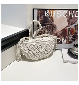 Macro shot of bohemian cream white macrame weave detail with elegant tassels on handbag