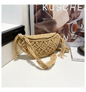 Detail of bohemian hand-woven beige crossbody bag with hollow diamond pattern and tassels