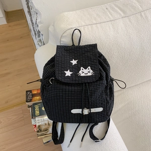 Detail of black plaid backpack with cat embroidery and adjustable side drawstring