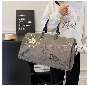 Close-up of durable canvas travel bag featuring artistic hand-drawn graffiti illustrations