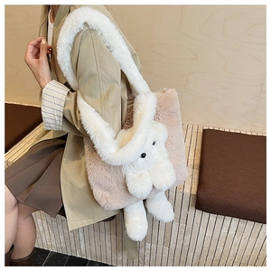 Detail of pink plush tote bag with 3D white rabbit doll and soft fuzzy shoulder strap