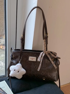 Brown embossed underarm shoulder bag with star charm and patterned scarf decoration