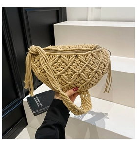 Detail of bohemian macrame sling bag with textured weave and decorative side tassels