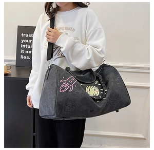 Detail of graffiti duffel bag with dual handles and adjustable shoulder strap