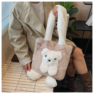 Detailed close-up of plush teddy bear charm on the khaki faux fur tote bag for women
