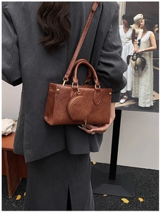 Detailed back view of vintage brown crossbody bag with detachable round coin purse