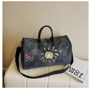 Close-up of distressed canvas travel bag with space graffiti and dual leather handles
