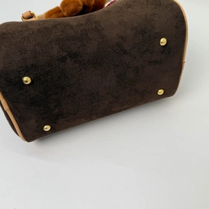 Detailed base view of vintage brown matte bag with gold protective metal rivets