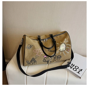 Close-up of canvas travel bag with graffiti prints on a cream bench in a soft lit room