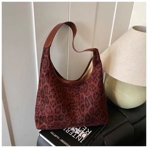 Detail of vintage leopard print tote bag with brown faux leather trim and sturdy handles