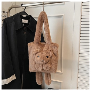 Detail of a brown plush bear tote bag with 3D cartoon elements on a long shoulder strap
