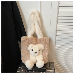Detail of soft plush tote bag with a cute 3D stuffed bear and contrast handles