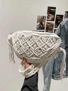 Handmade white macramé dumpling bag with geometric weaving and bohemian tassels