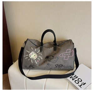 Detail view of grey canvas travel bag featuring artistic cartoon graffiti and sturdy handles