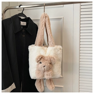 Detail of plush teddy bear tote bag with soft 3D bear design on white faux fur