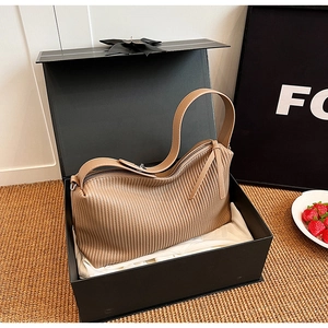 Detailed view of khaki pleated tote bag with premium gift box and dust bag set