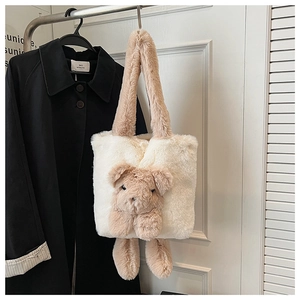 Close-up of plush tote bag featuring soft cream faux fur and cute brown bear ornament
