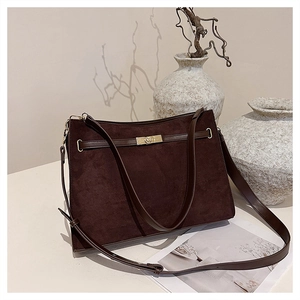 Detailed view of dark brown frosted suede shoulder bag with elegant metal turn-lock buckle