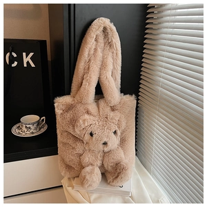 Detailed view of plush teddy bear tote bag with fuzzy texture and cute 3D bear decoration