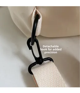 Close-up of a durable detachable hook and woven strap on a minimalist canvas backpack