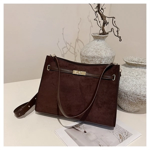 Detail view of dark coffee matte suede bag featuring gold metal buckle and strap