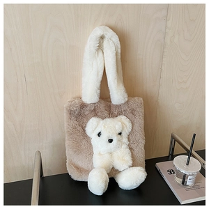 Detailed view of plush teddy bear tote bag with soft brown faux fur and white plush handles