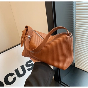 Close-up of brown vintage pleated tote bag featuring high-quality leather and silver twist lock