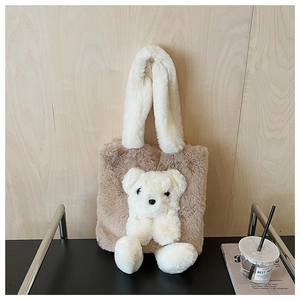 Close-up of fluffy brown plush tote bag with white faux fur handle and 3D teddy bear detail