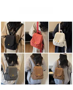 Mini canvas backpacks in six colors showing flip-top design and yellow button details