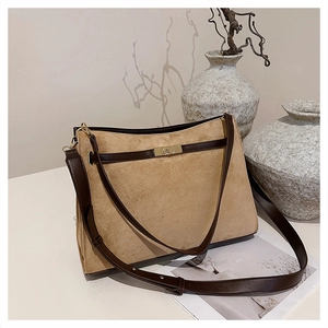 Detail of vintage tote bag with suede finish, leather trim and gold metal twist lock buckle