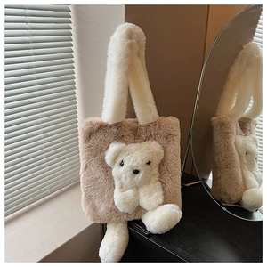 Close-up of soft plush brown tote bag with cute white 3D teddy bear decorative charm