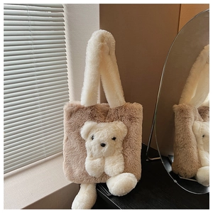 Close-up of fluffy brown plush tote bag with a 3D white teddy bear and soft shoulder strap