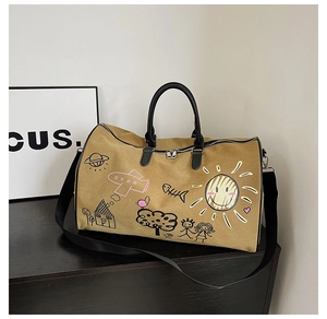 Detail of khaki canvas travel bag with colorful graffiti patterns and sturdy black handles