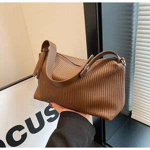 Close-up of a brown pleated Boston handbag in soft faux leather with retro textures