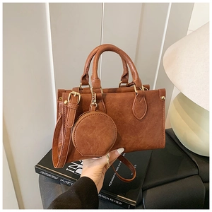 Caramel brown handbag with matching round pouch and adjustable shoulder strap detail