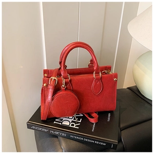 Detail of red PU leather handbag with gold hardware and matching round coin purse charm