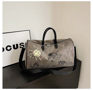 Close-up of a dark grey graffiti travel bag with durable metal zippers and leather handles