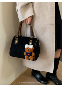 Retro black matte Boston bag with brown leather handles and a cute bear charm pendant